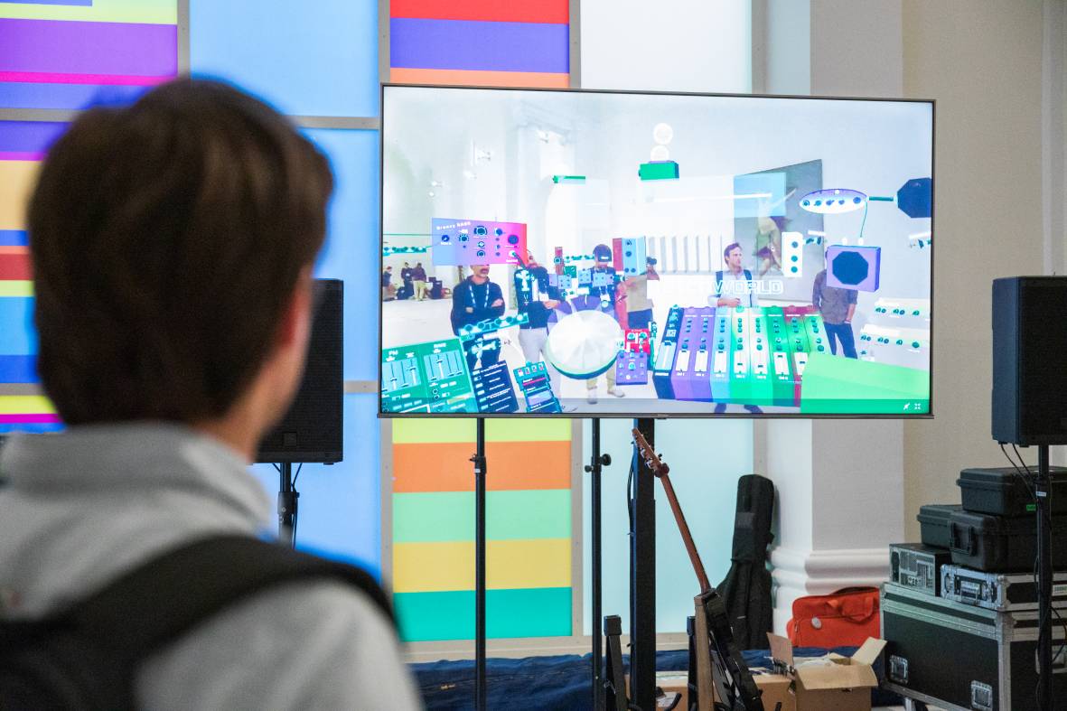 a man looking at a virtual studio on a screen 