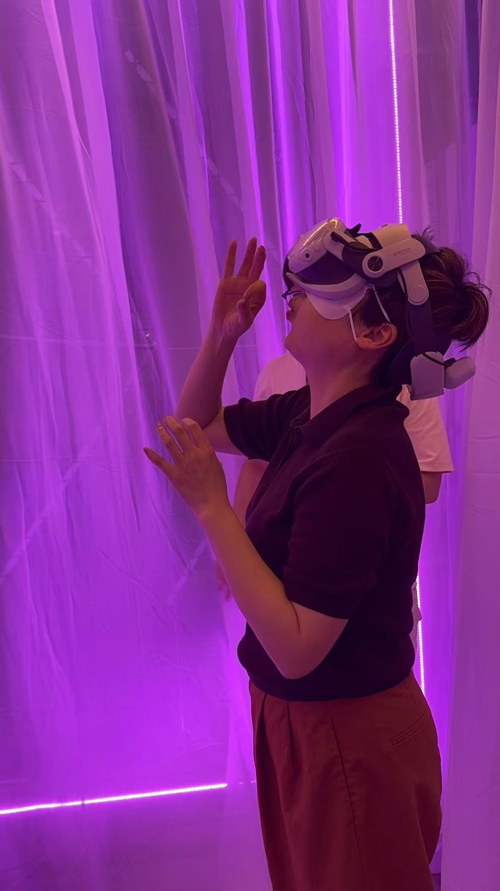 Participant wearing a VR headset inside the Empathy Creatures installation booth