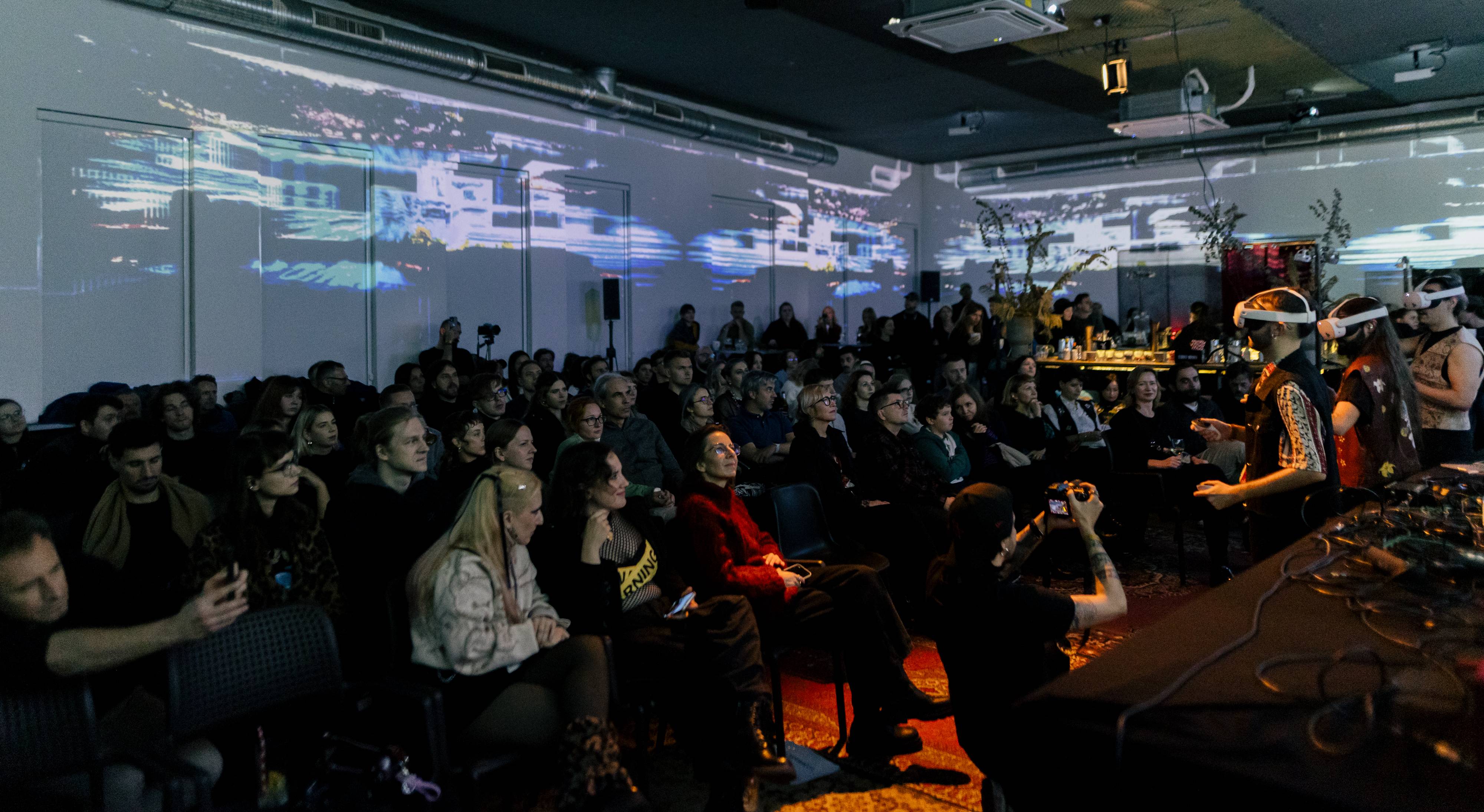 Audience members watching ALHAJA’s audiovisual world unfold during the live performance
